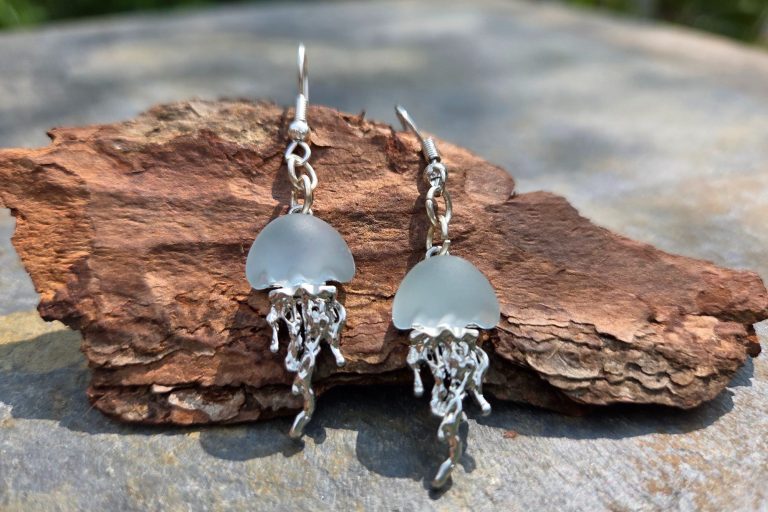 Red heart pompom Red rhinestone heart attached to a gold-tone keyring, with the addition of a red pom-pom a gold tone shell a red and white fish charm